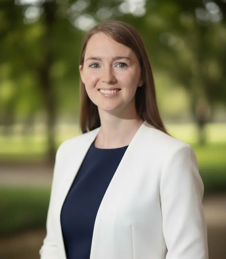 Allisha McCartney, founder of HRish Solutions, smiling in a white blazer outdoors