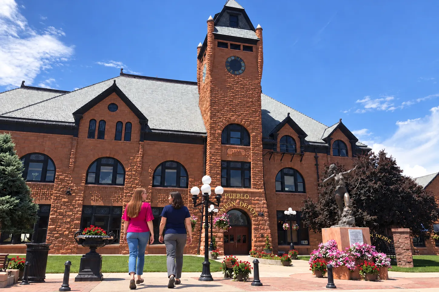 Allisha McCartney and another woman walking toward the Pueblo Union Depot